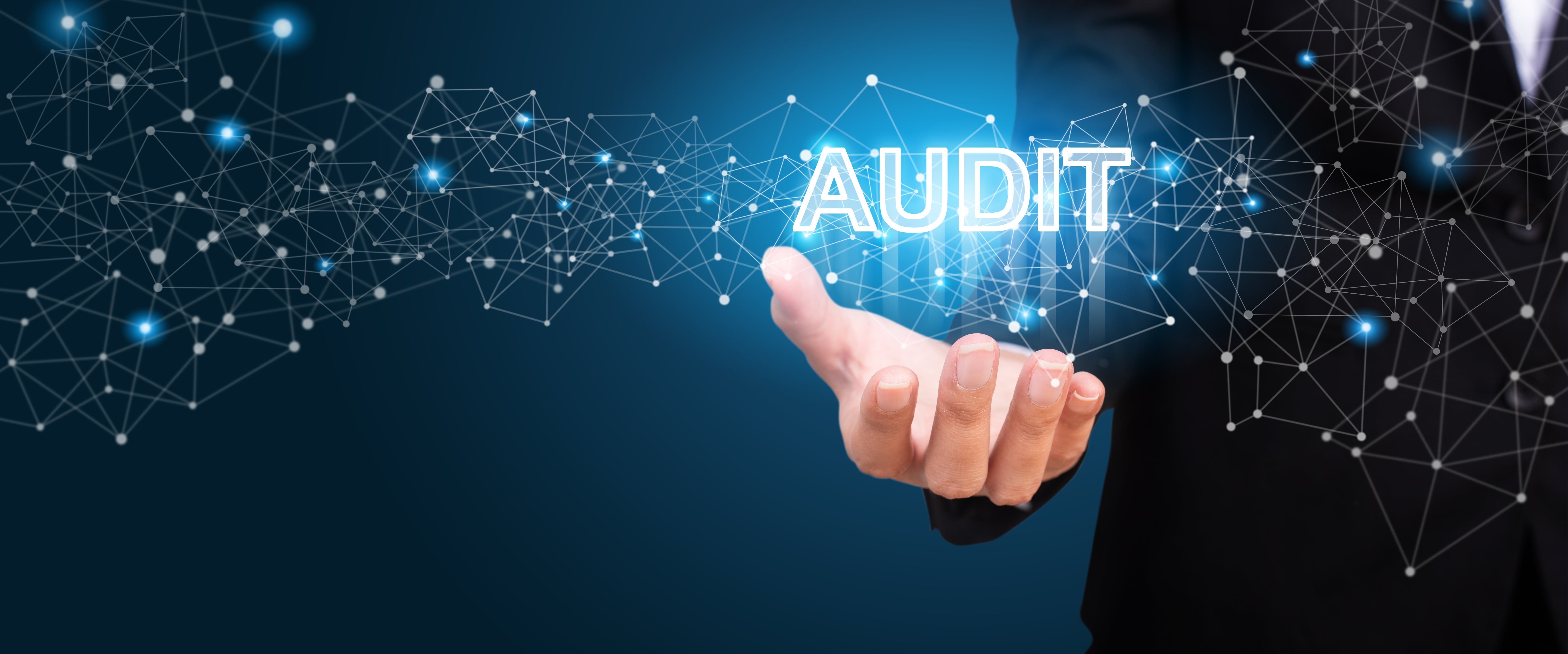 The word 'audit' hovering over a hand, showing benefits of continual RPA audits over manual audits.