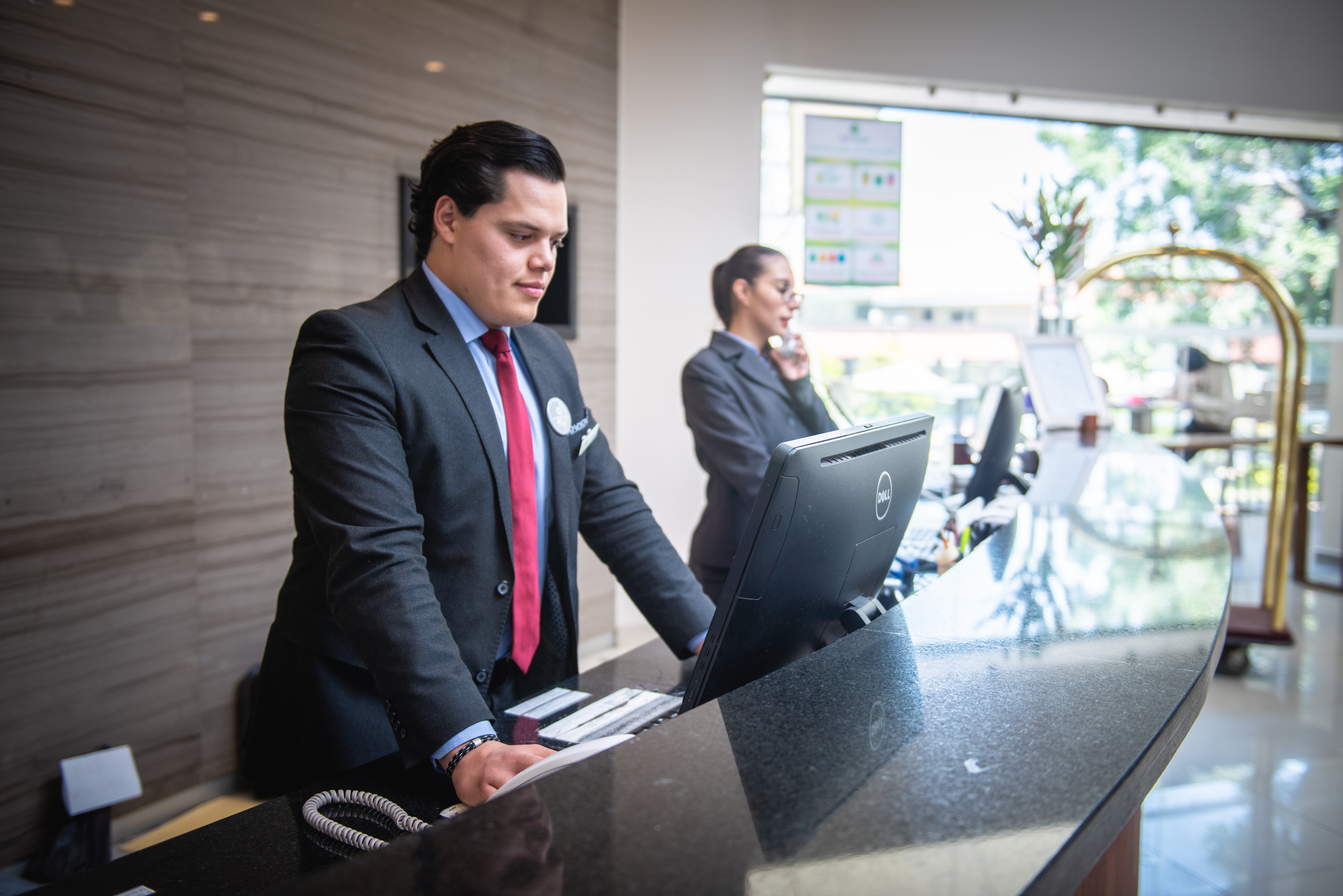 Receptionist stood at check-in desk